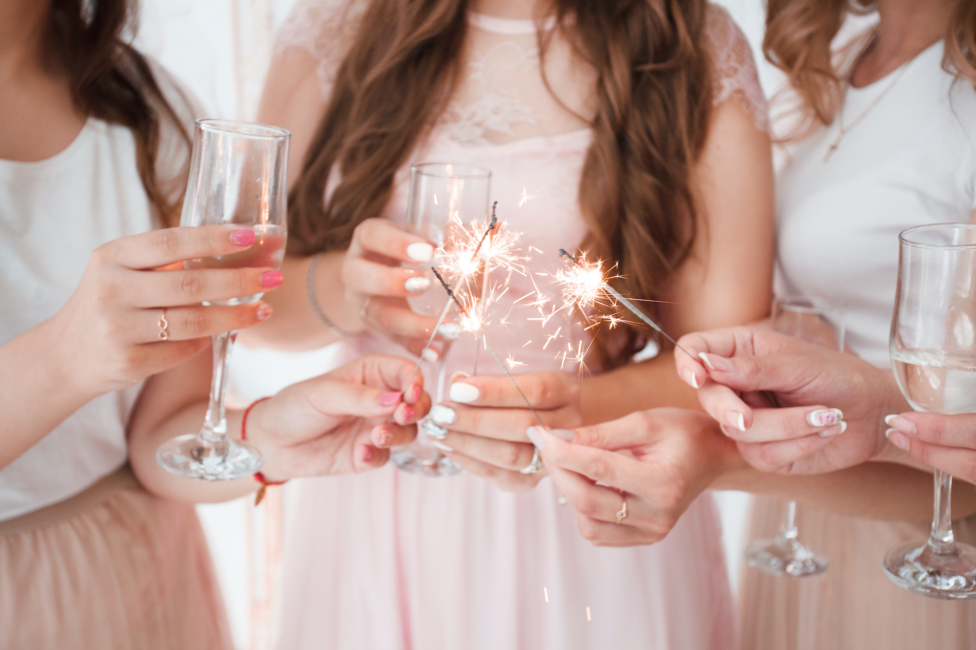 gorgeous cheerful bachelorette party in pink with champagne, sparklers. Pretty girls having fun at a bachelorette party